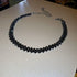 Black Luxury Rhinestone Chain Choker with dark glossy crystals laid on cream tabletop for modern contrast | Oria Jewel