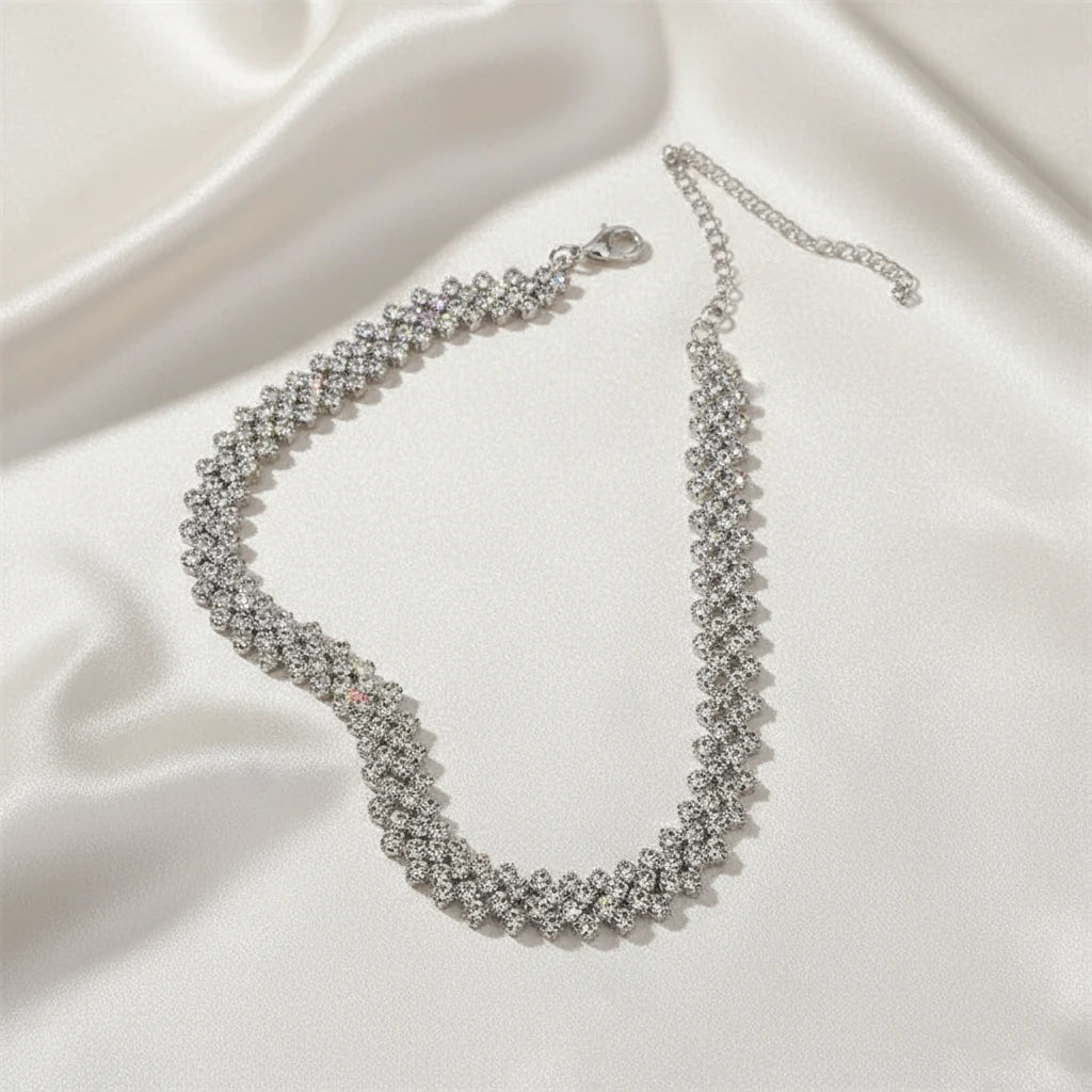 Luxury Rhinestone Chain Choker laid out on ivory satin fabric, highlighting sparkle and craftsmanship | Oria Jewel