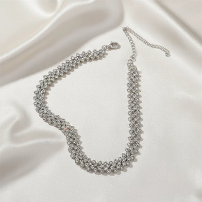 Luxury Rhinestone Chain Choker laid out on ivory satin fabric, highlighting sparkle and craftsmanship | Oria Jewel