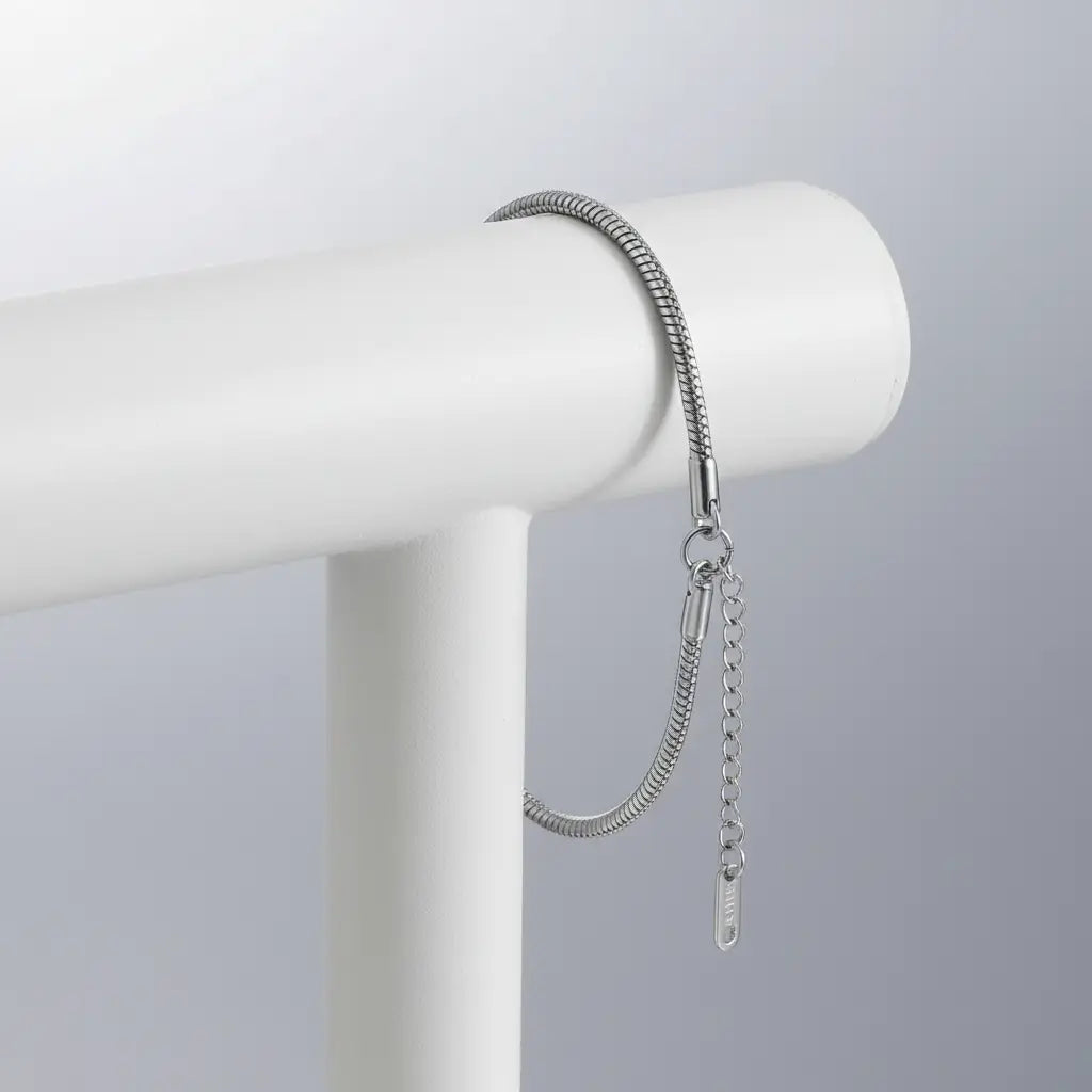 Sleek silver variant of Minimalist Gold Chain Bracelet draped over a white display bar with adjustable extender chain visible | Oria Jewel