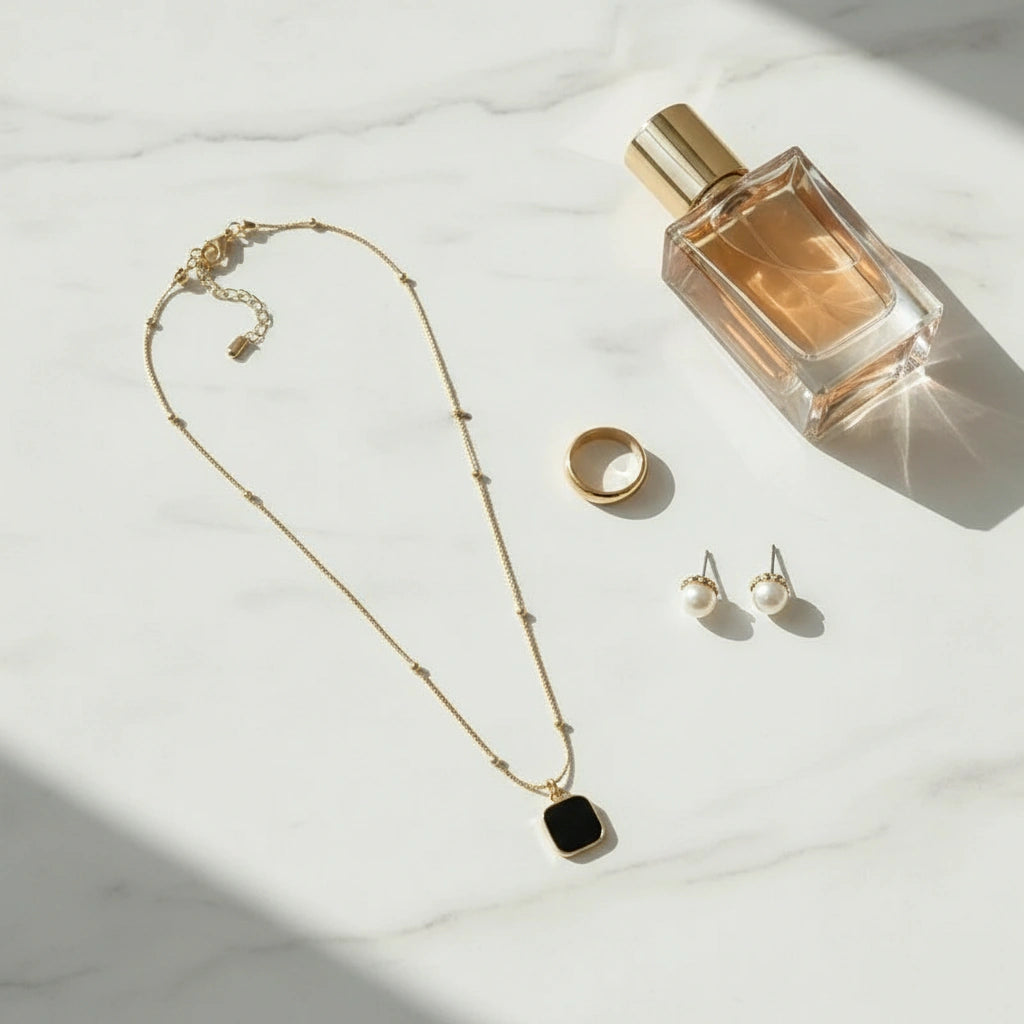 Minimalist Square Pendant Choker displayed with perfume, a ring, and stud earrings on marble surface | Oria Jewel