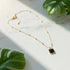 Minimalist Square Pendant Choker on a marble surface with tropical leaves | Oria Jewel
