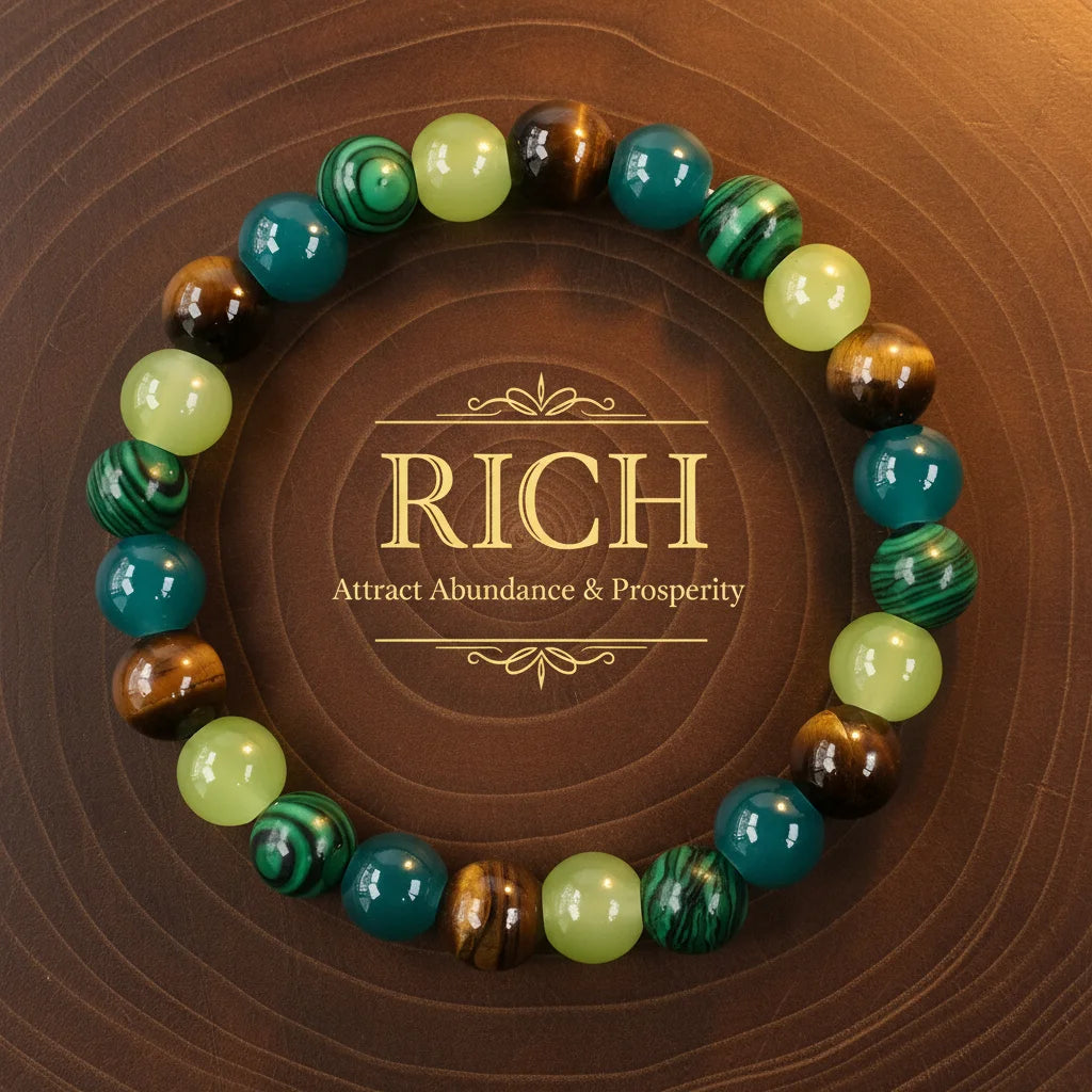 Circular Money Attraction Tigers Eye Bracelet made of green, yellow jade, teal and brown tiger’s eye beads arranged around the word “RICH – Attract Abundance &amp; Prosperity” on a wooden background | Oria Jewel