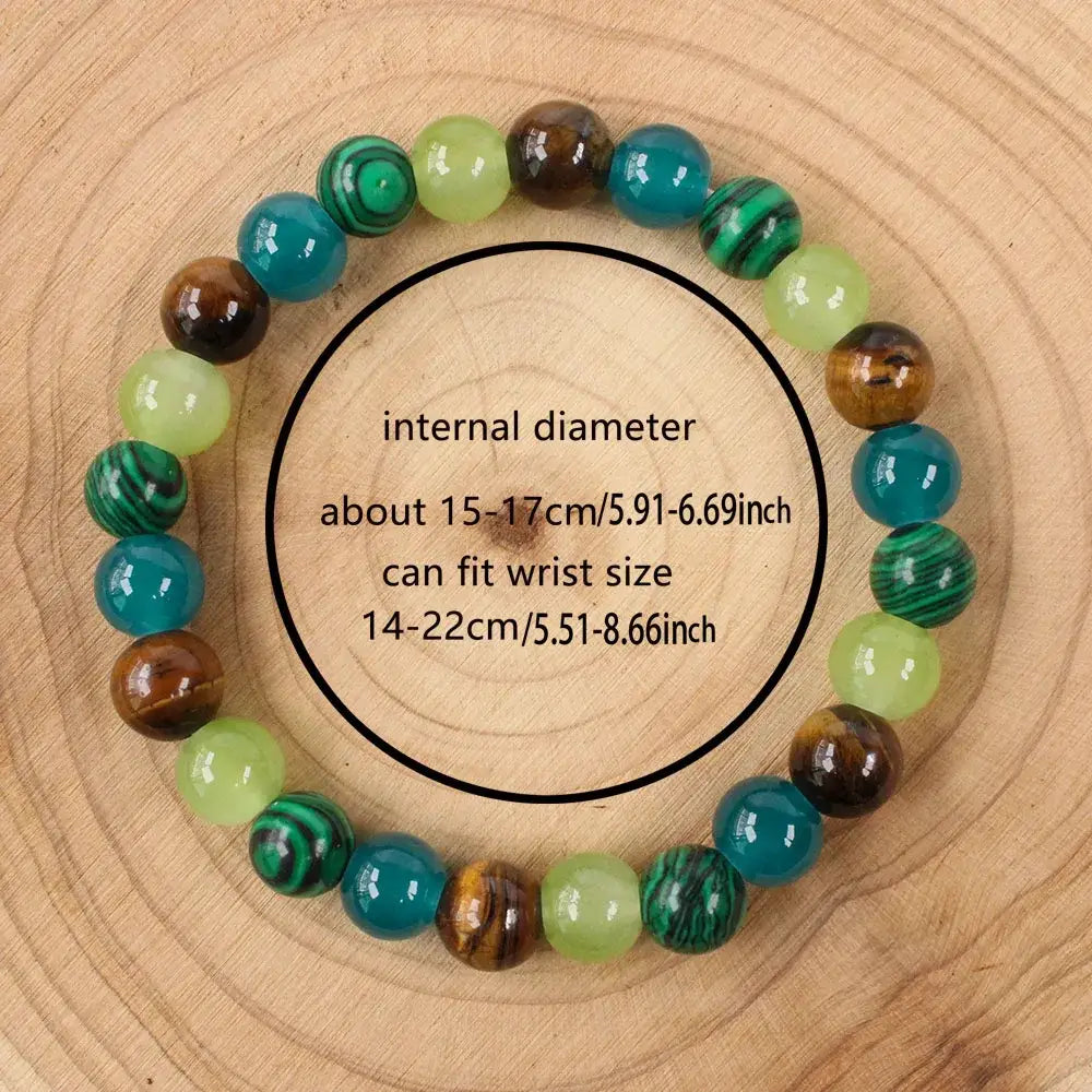 Sizing guide showing the Money Attraction Tigers Eye Bracelet on a wood-grain background with text indicating internal diameter and wrist size range, focusing on the round multicolor gemstone beads | Oria Jewel