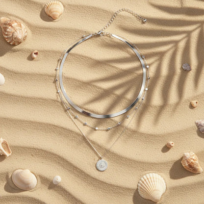Multi Layer Silver Circle Chain Necklace displayed on sand among seashells under soft sunlight | Oria Jewel