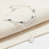 Multi Layer Silver Circle Chain Necklace displayed on soft cream fabric showing detailed layered chains and circle pendant | Oria Jewel