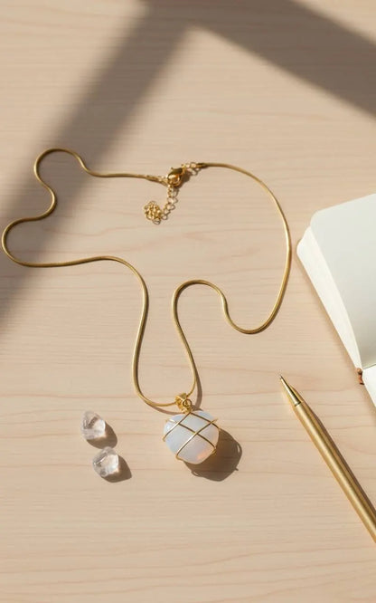 Desk flat lay with notebook, pen, crystals, and gold chain Natural Moonstone Pendant | Oria Jewel 