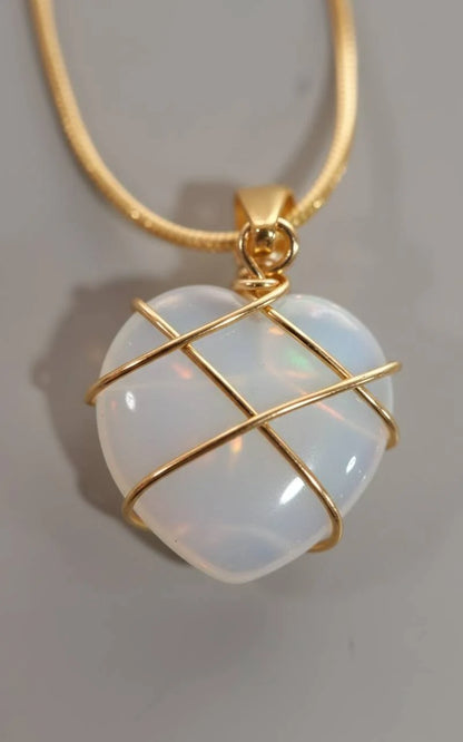 Close-up of heart-shaped Natural Moonstone Pendant wrapped in gold wire | Oria Jewel