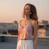 Woman on rooftop at sunset wearing silky top and Natural Moonstone Pendant | Oria Jewel