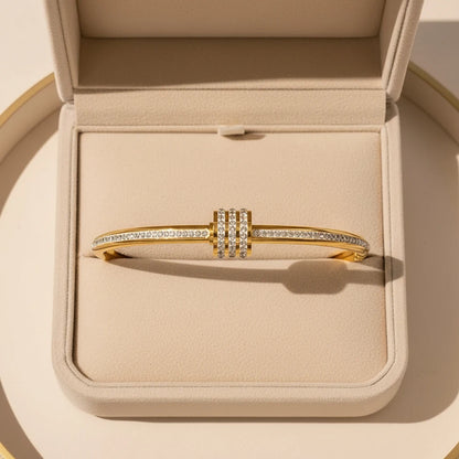 Gift-ready presentation of the Pavé Stackable Gold Bangle nestled in a beige jewelry box, emphasizing its luxurious gold shine and three stacked pavé crystal rows as the perfect special-occasion present | Oria Jewel