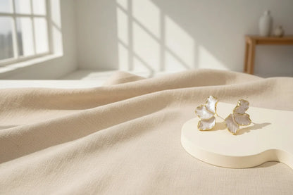 Pearl Petal Statement Stud Earrings on display platform with window shadows | OriaJewel