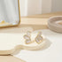 Pearl Petal Statement Stud Earrings close-up on modern tabletop | OriaJewel