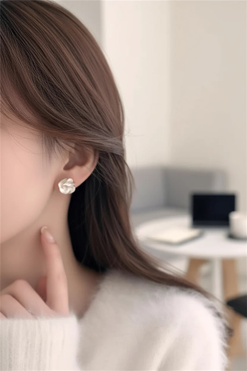 Close-up Pearl Rosette Stud Earrings worn on ear with soft blur background | OriaJewel