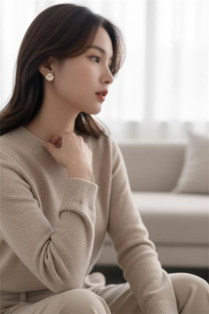 Pearl Rosette Stud Earrings worn on model in cozy neutral setting | OriaJewel