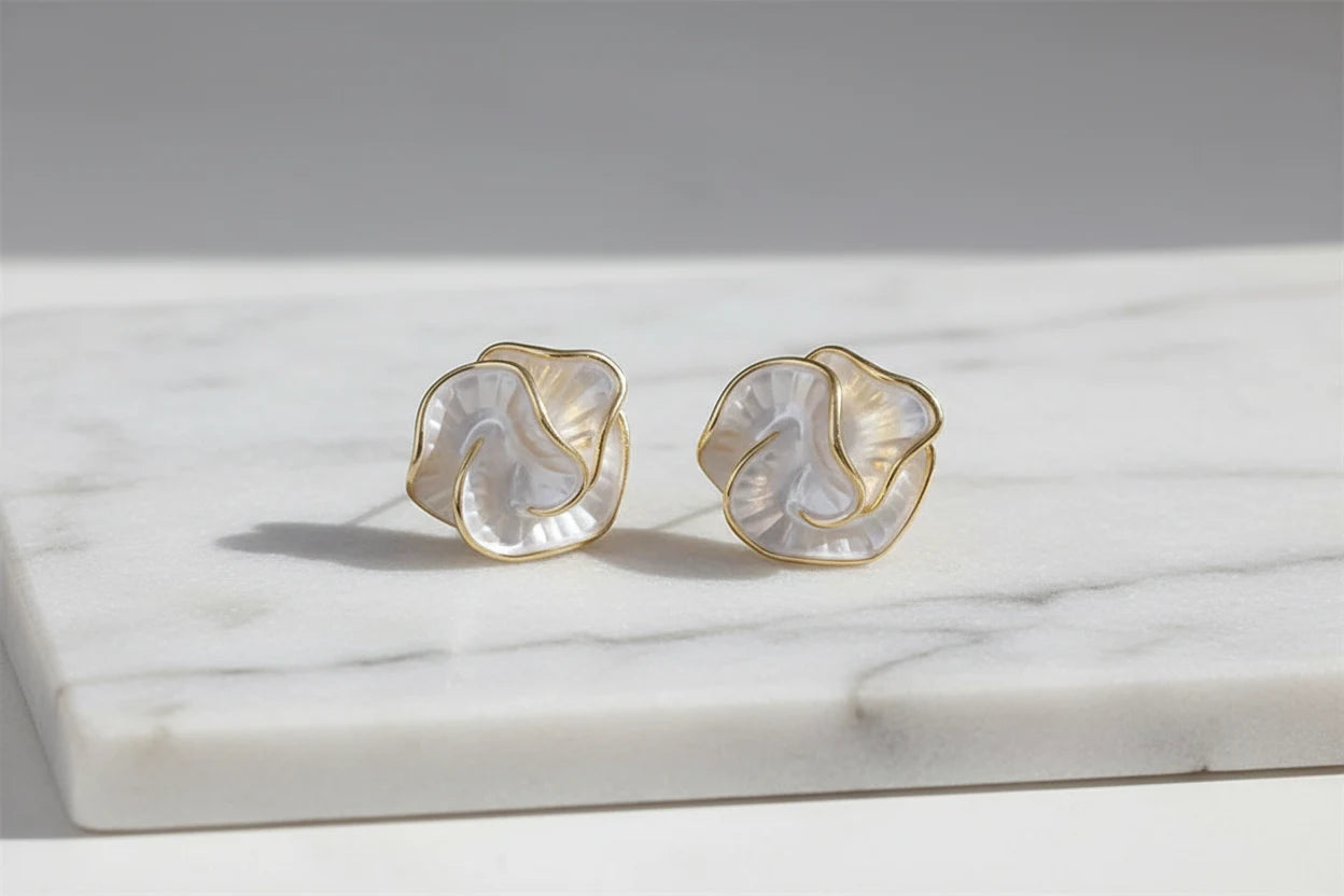 Pearl Rosette Stud Earrings on marble surface in soft daylight | OriaJewel