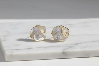 Pearl Rosette Stud Earrings on marble surface in soft daylight | OriaJewel