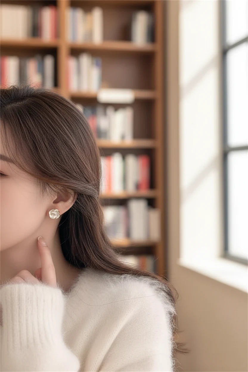 Pearl Rosette Stud Earrings worn on model near bookshelf window | OriaJewel