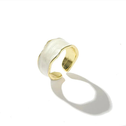 Pearl White Open Wave Ring product-only shot on a clean white background with a crisp shadow, featuring the open cuff shape, pearl-white enamel surface, and gold-tone lining | OriaJewel
