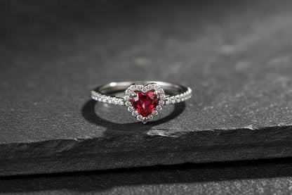 Close-up product shot on dark stone surface, Red Heart Halo CZ Ring | OriaJewel