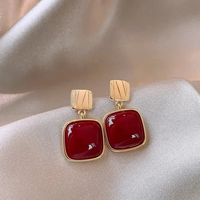 Red Square Drop Earrings close-up on soft satin fabric background | OriaJewel