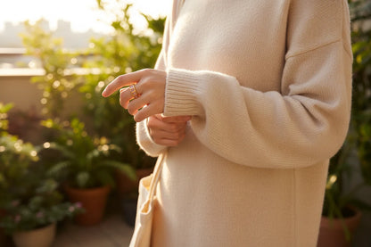 Rose stone band ring on a hand outdoors at golden hour, soft knit sweater and greenery background | OriaJewel