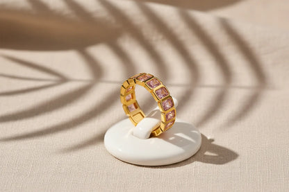 Rose stone band ring on a small white display stand with artistic shadow patterns on textured fabric | OriaJewel