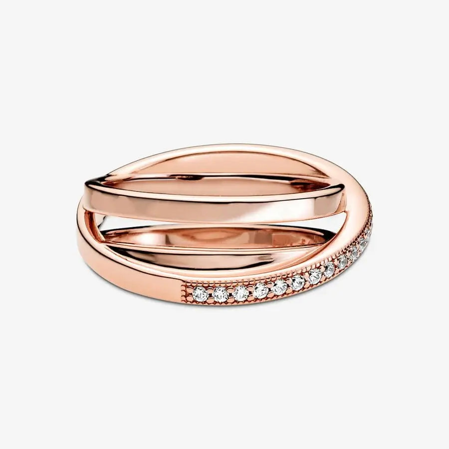 Rose Gold Criss Cross CZ Band Ring on a clean white background, close-up showing layered criss-cross rose gold bands with one pavé CZ row and delicate beaded/milgrain edging | OriaJewel