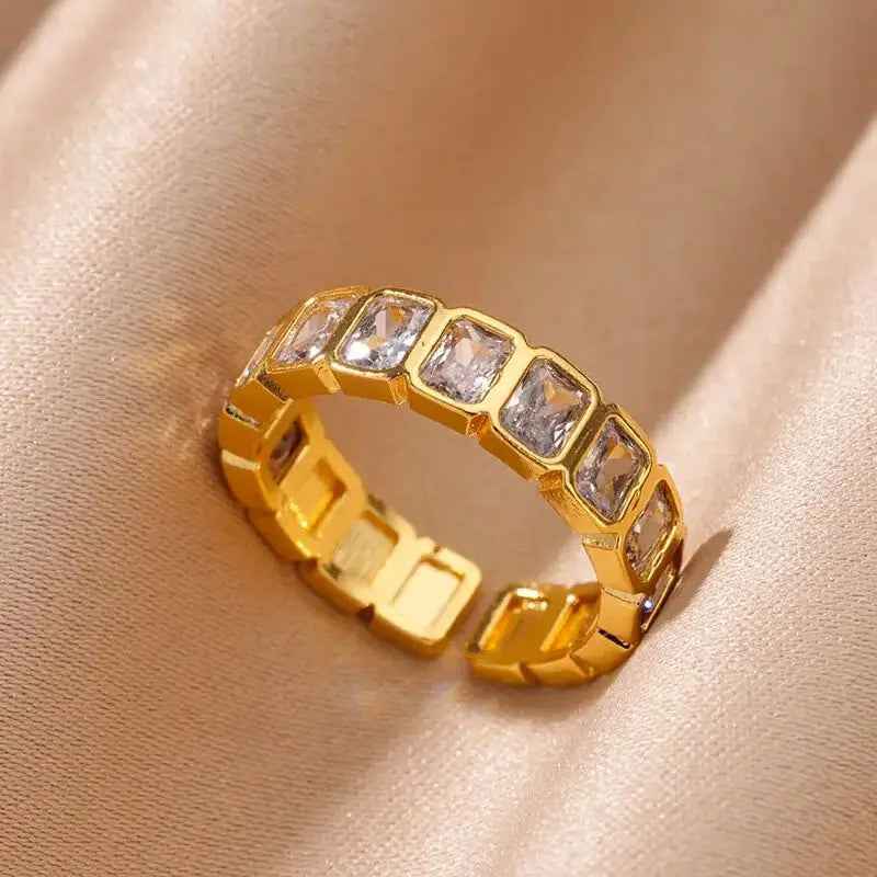 Gilded Glow Crystal Ring featuring a luxurious gold band adorned with sparkling crystals on a silky surface | Oria Jewel
