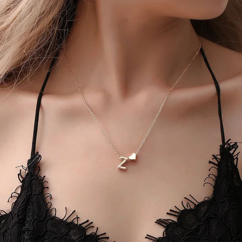 woman wearing personalised heart necklace gold with minimal outfit | Oria Jewel