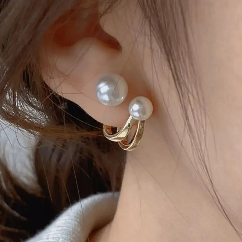 Close-up: ear wearing beautiful freshwater pearl stud earrings with gold accents | Oria Jewel