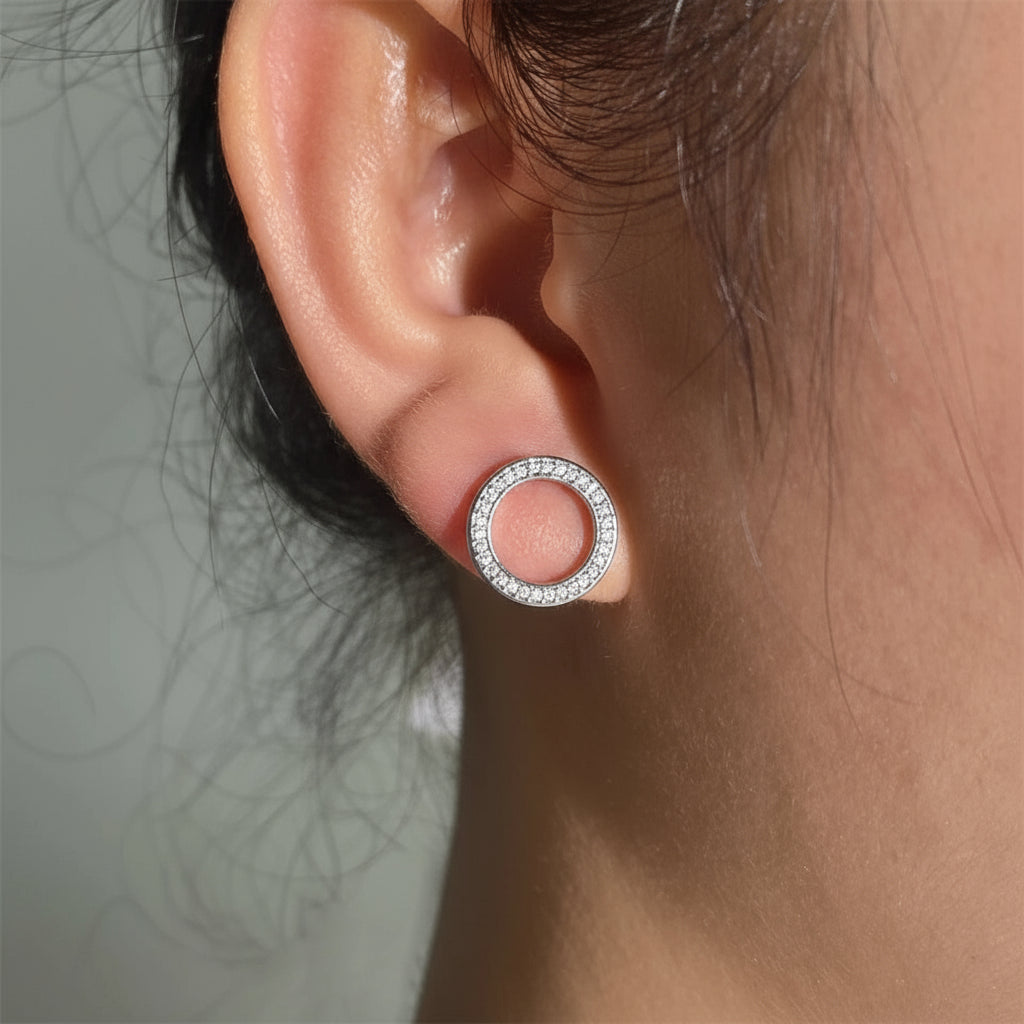 Hollow Zircon Earrings showcasing a circular design with sparkling zircon stones, perfect for adding elegance.