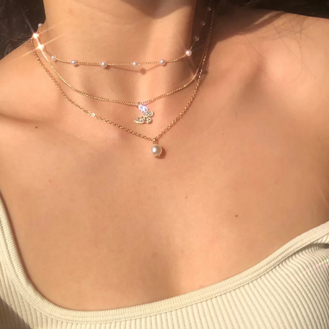 Model wearing Retro Butterfly Chain Set at brunch in natural light | Oria Jewel