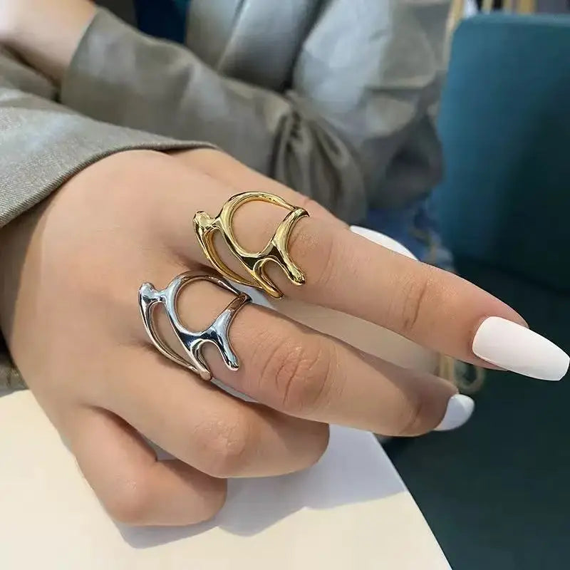 Stylish hand wearing a Sculpted Metal Statement Ring in silver and gold, showcasing modern design and elegance | Oria Jewel