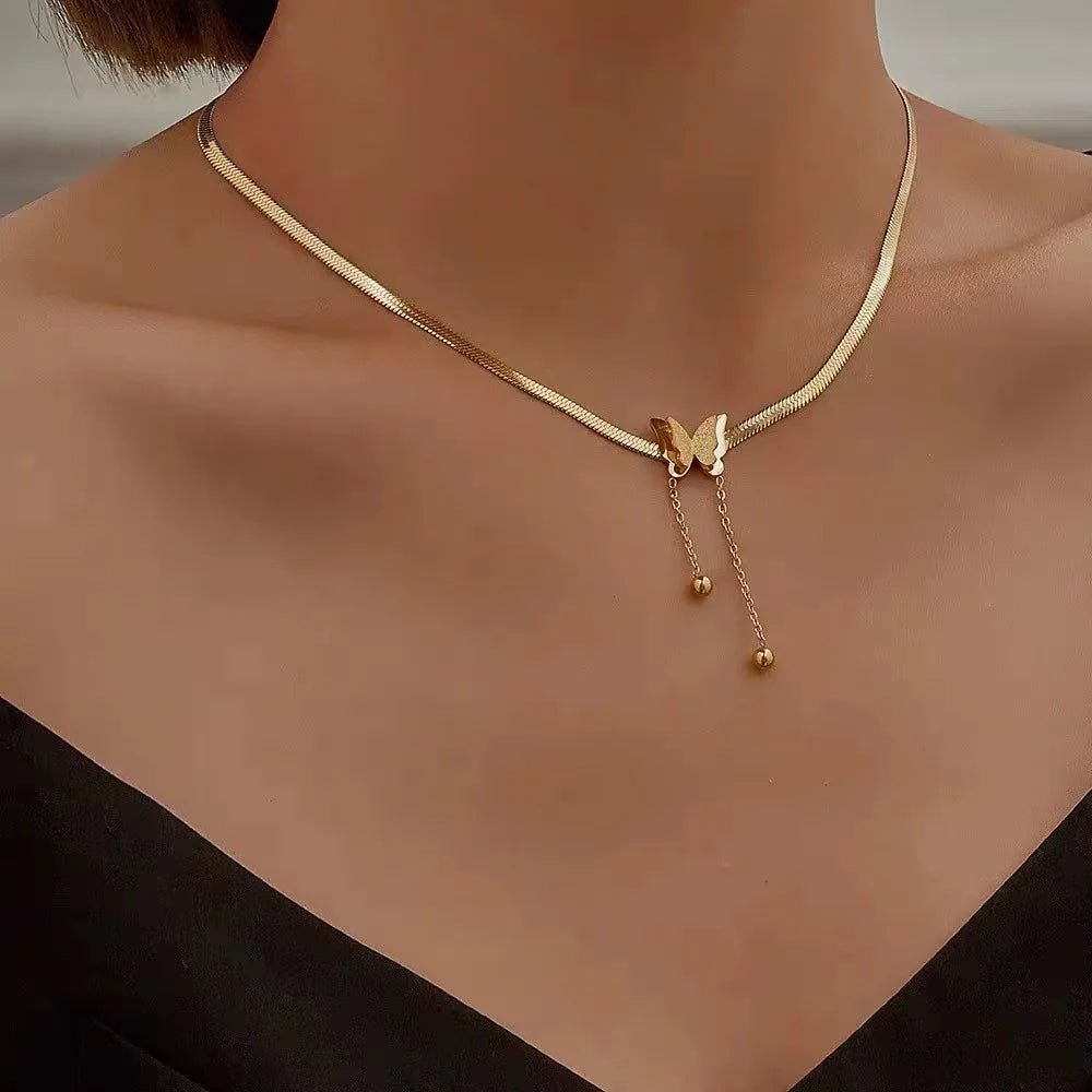 Woman wearing Gold Butterfly Chain Necklace with layered accessories | Oria Jewel