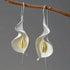 Elegant teardrop earrings: brushed silver, gold-toned calla lily forms, on branch | Oria Jewel