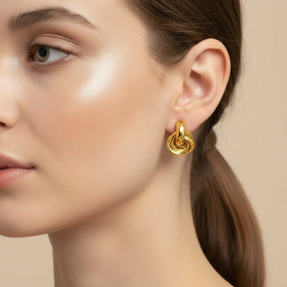 Close-up of a model wearing Elegant Knot Hoop Earrings, showcasing the elegant gold design and stylish appearance | Oria Jewel