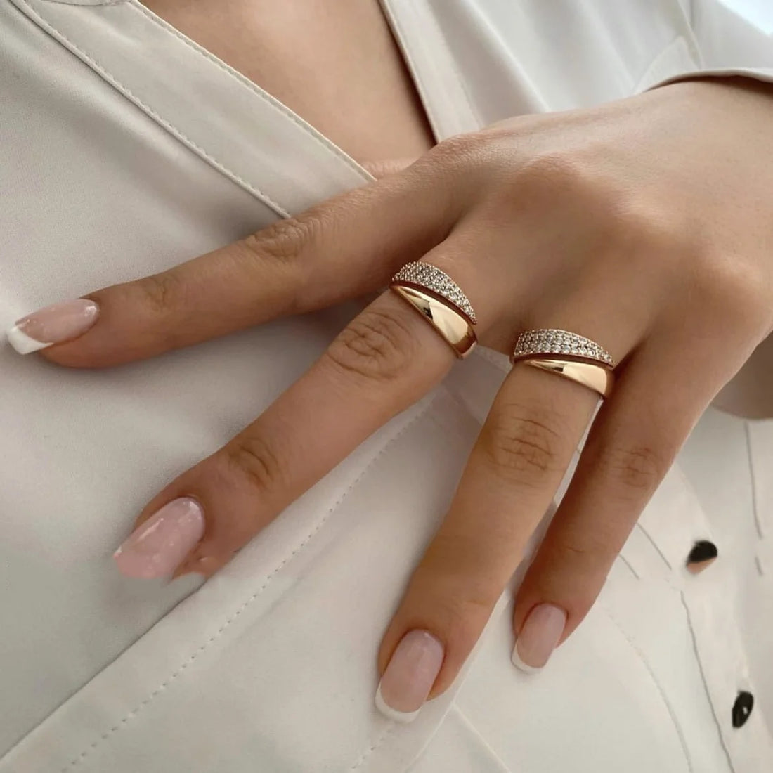 Two elegant Golden Rock Crystal Rings sparkle on a hand against white fabric | Oria Jewel