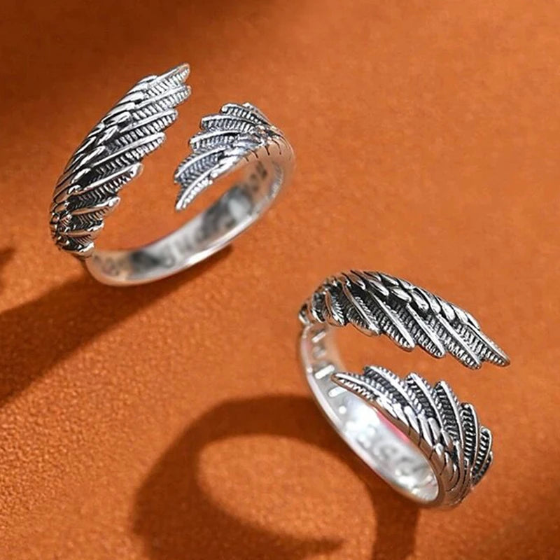 Two detailed oxidized silver Angel Bat Wrap Rings on a warm orange surface | Oria Jewel