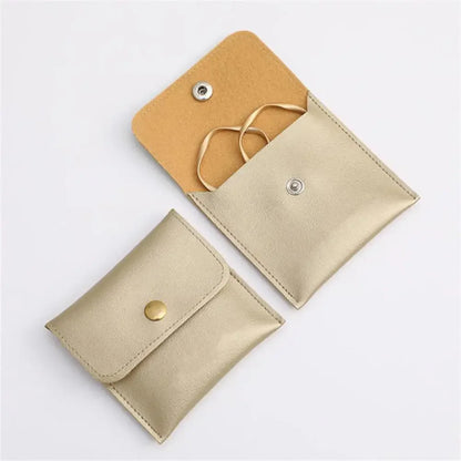 Soft Snap Jewelry Pouch in gold, travel-friendly, perfect for storing rings and earrings.