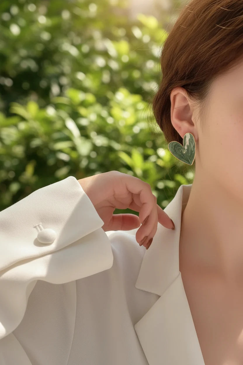 Sage Green Marble Heart Stud Earrings worn by model outdoors with greenery | OriaJewel