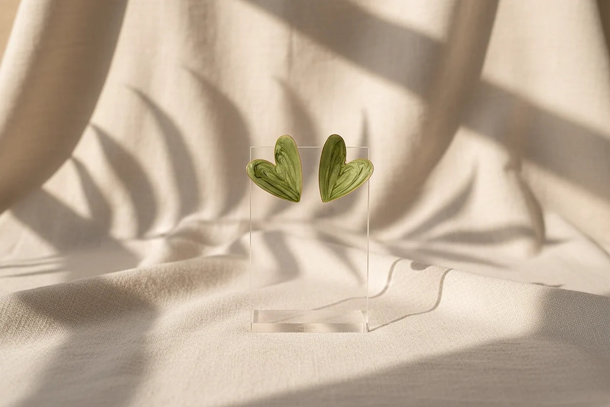 Sage Green Marble Heart Stud Earrings on clear stand with soft fabric shadows | OriaJewel