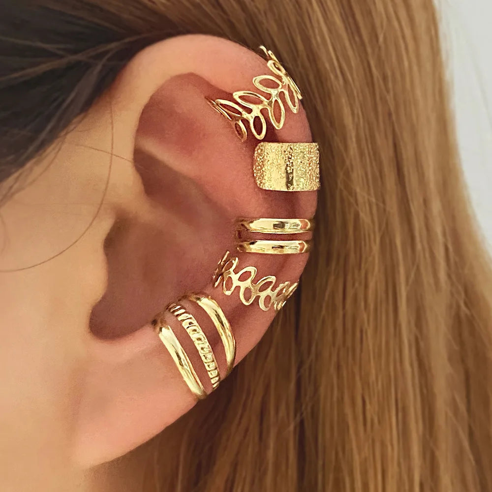 Close-up of an ear adorned with a shiny gold Minimalist Ear Clip Set | Oria Jewel