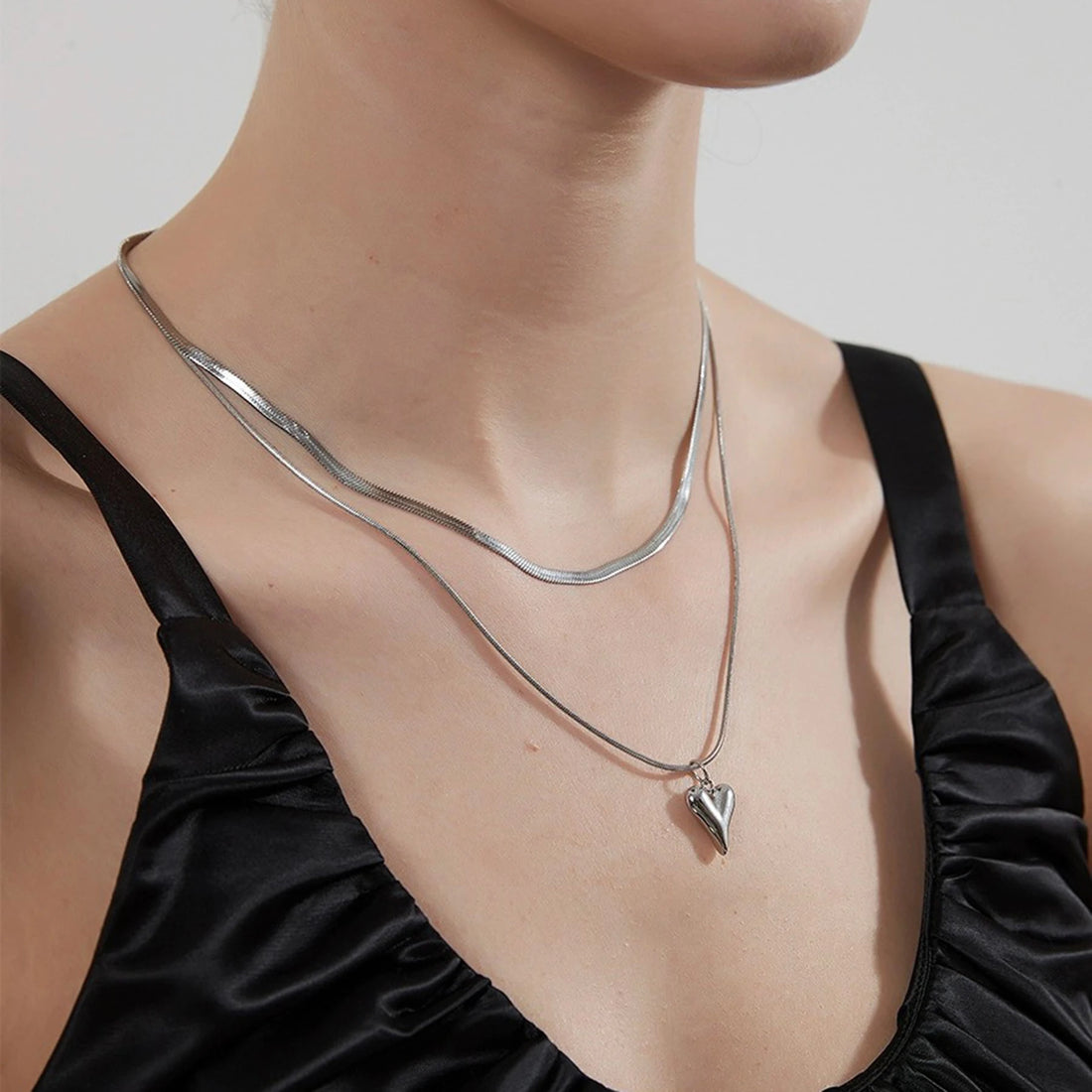 Model wearing adjustable heart pendant layered necklace with dress | Oria Jewel