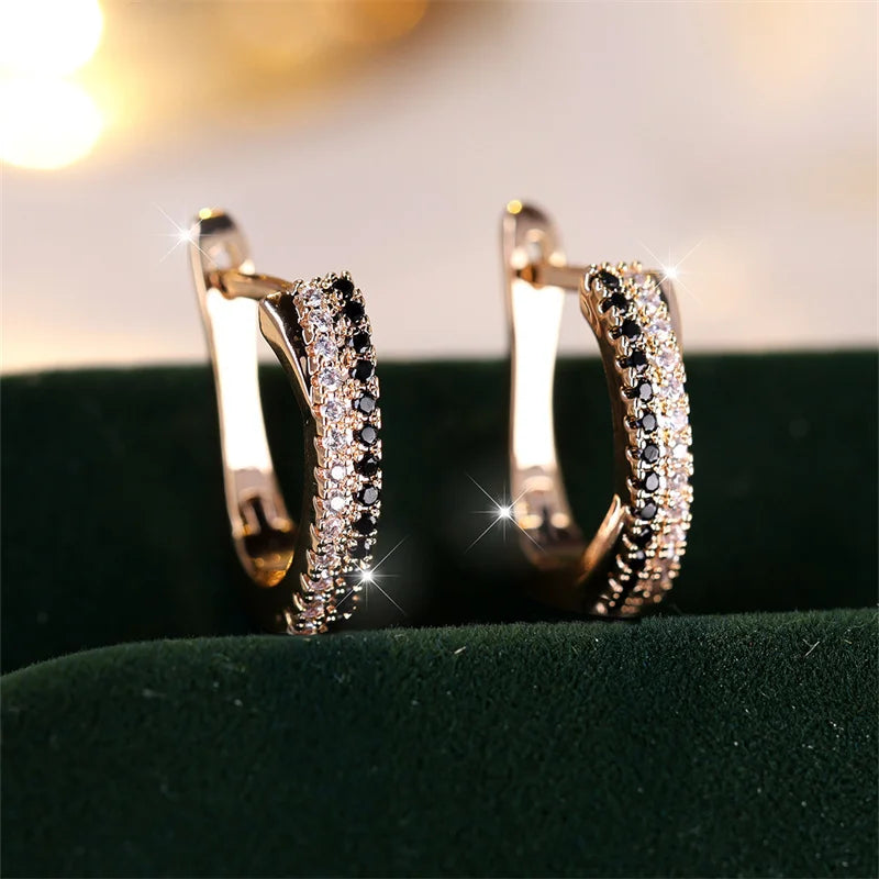 Sparkling gold crystal hoop earrings with black and white stones on velvet | Oria Jewel