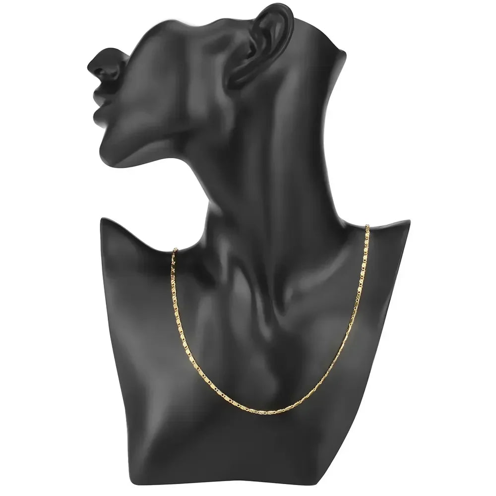 Gold flat chain choker displayed on a black mannequin bust, showcasing its sleek and minimalist design | Oria Jewel