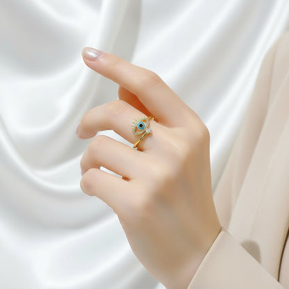 Elegant hand wearing a Blue Crystal Evil Rings, showcasing intricate design and sparkling details | Oria Jewel