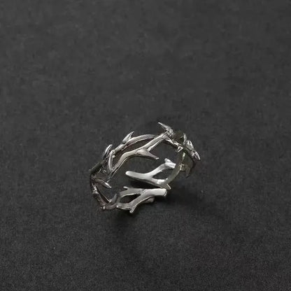 Silver Antler Wrap Ring set arranged on a matte black background with spiky branch-shaped silver pieces, showcasing the rugged wrap aesthetic and sharp accents | OriaJewel