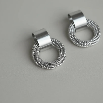 Silver Circle Drop Stud Earrings close-up on gray background | OriaJewel