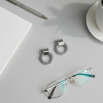 Silver Circle Drop Stud Earrings flat lay with glasses and pen | OriaJewel