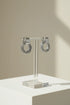 Silver Circle Drop Stud Earrings on clear stand with soft shadows | OriaJewel